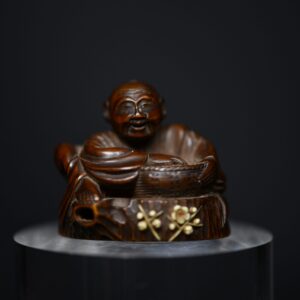 Netsuke man on stump wood