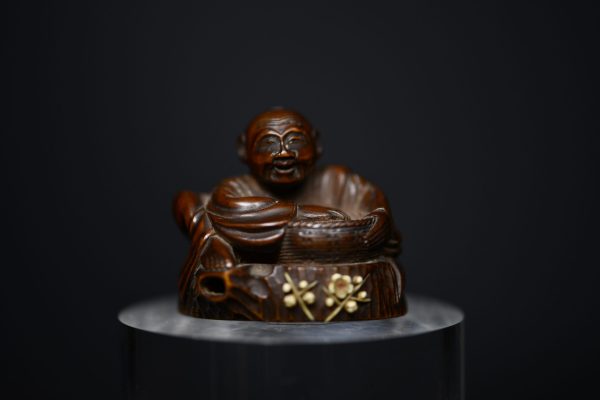 Netsuke man on stump wood